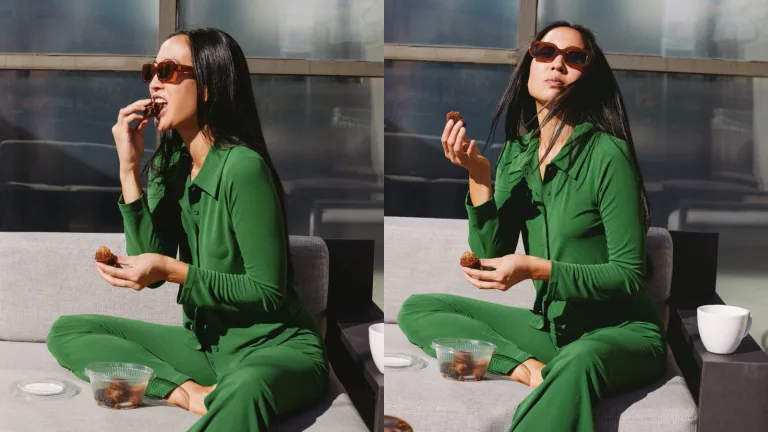 Woman in a green outfit sitting outdoors, eating a Sakara muffin with a cup of coffee.
