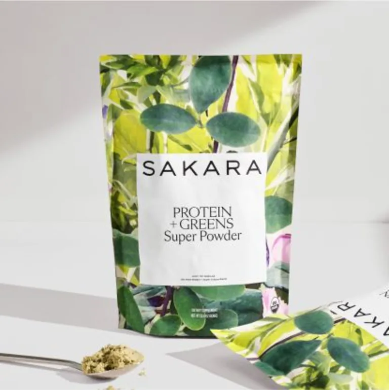 Sakara Life Protein + Greens Super Powder" Image of two pouches, one standing up and one on its side alongside a spoon with the powder in it