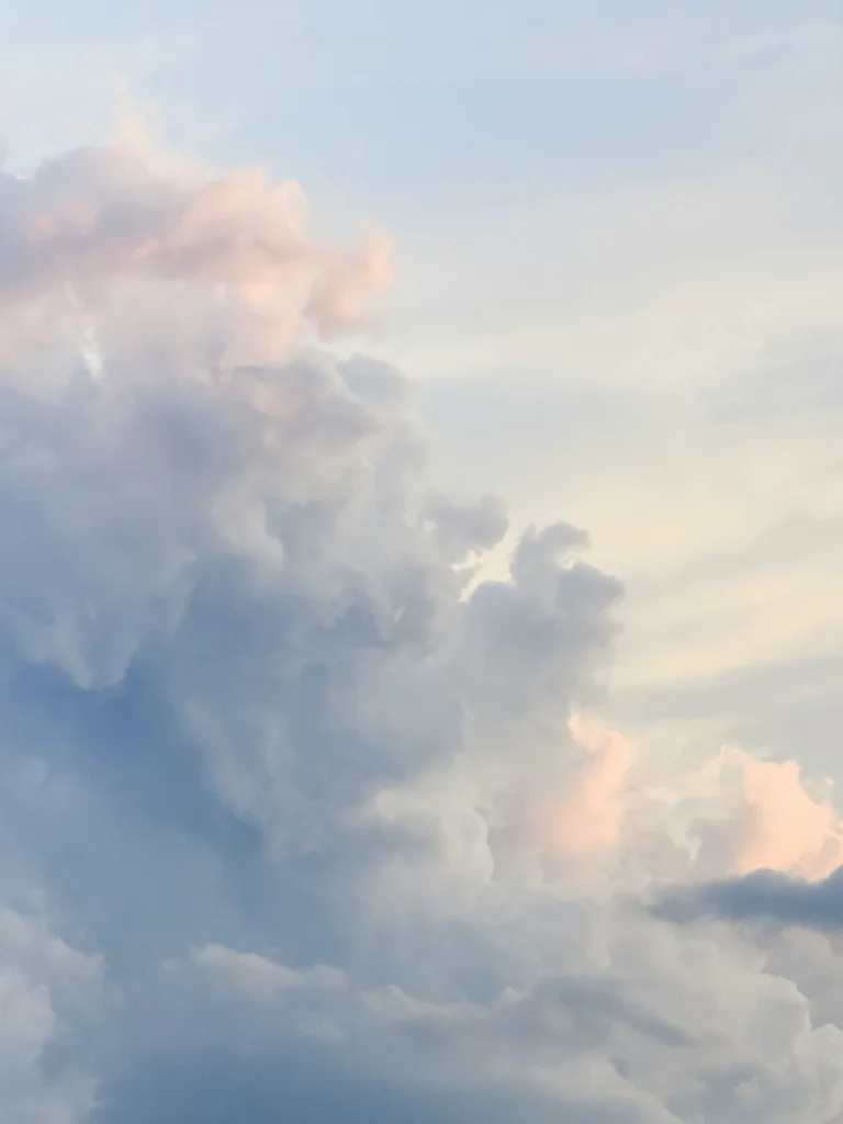 Soft pastel sky with clouds at sunset.