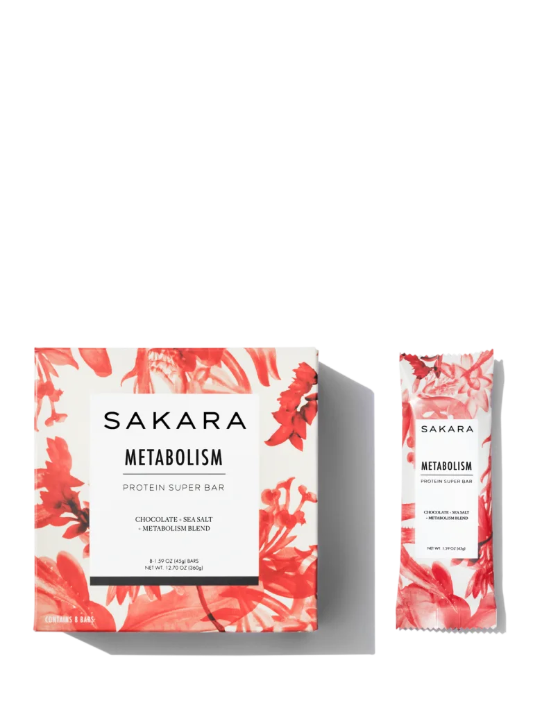 Sakara Metabolism Protein Super Bar 8-count box and individually wrapped bar in white and red floral packaging, chocolate sea salt flavor, 8 bars, featuring metabolism blend.
